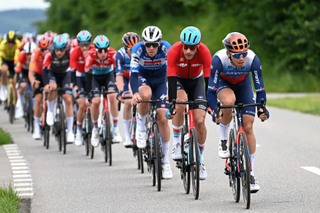 Jayco AlUla lead the peloton on stage 3 of the Tour de Suisse