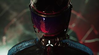 A driver in a black outfit stares down the camera