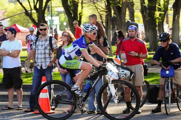Sue Butler (River City Bicycles) riding in front of the downtown crowd