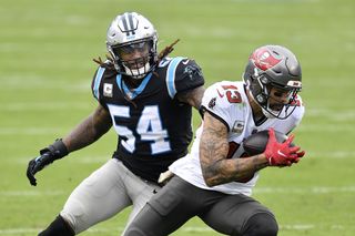 Tampa Bay Buccaneers receiver Mike Evans catches a pass in front of Shaq Thompson of the Carolina Panthers during their game at Bank of America Stadium on Nov. 15, 2020 in Charlotte, North Carolina.