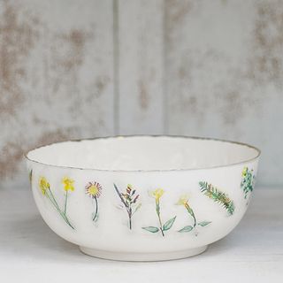 white bowl with flower designed on white surface