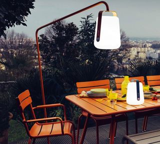 roost episode 3 - orange outdoor table and chairs with modern outdoor lighting - Pic-credit-Nedgis