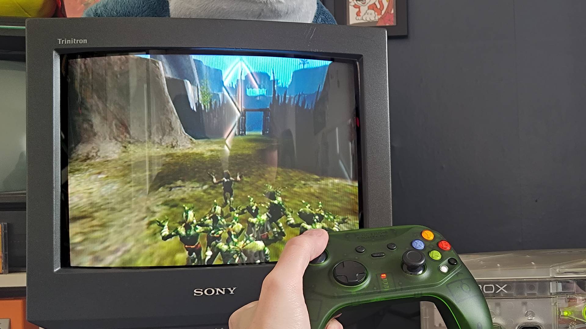 Retro Fighters Hunter controller being used to play Oddworld: Munch's Odyssey on OG Xbox with Abe and pals sneaking.