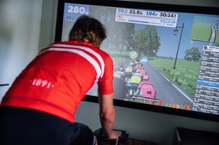 Male cyclist riding indoors on Zwift
