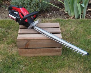 image of the Cobra H5024V Li-Ion cordless hedge trimmer in a garden