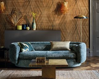 A living room with a yellow wallpaper and green sofa