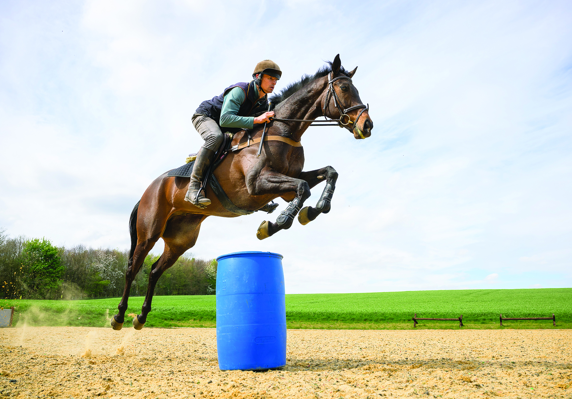 Tom Strawson and Public Address jump a barrel in a schooling session at home.