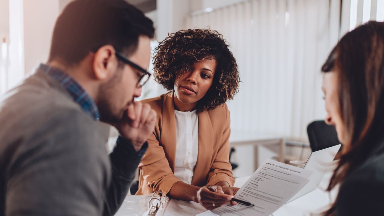 Couple speaking with a financial advisor