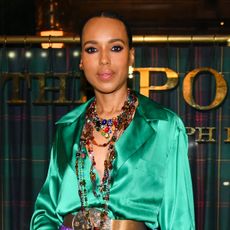 Kerry Washington wears a bright green blouse with layered necklaces