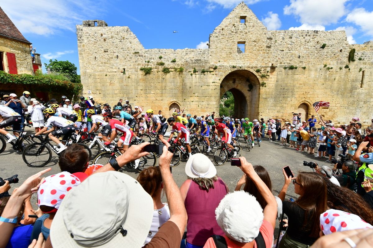 The Tour peloton passes through the Domme walls during stage 10