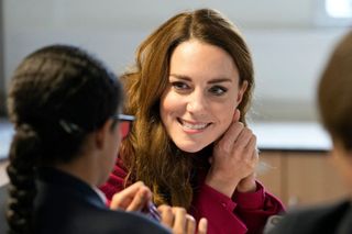 Britain's Catherine, Duchess of Cambridge interacts with students during a visit to Nower Hill High School in Harrow, north London