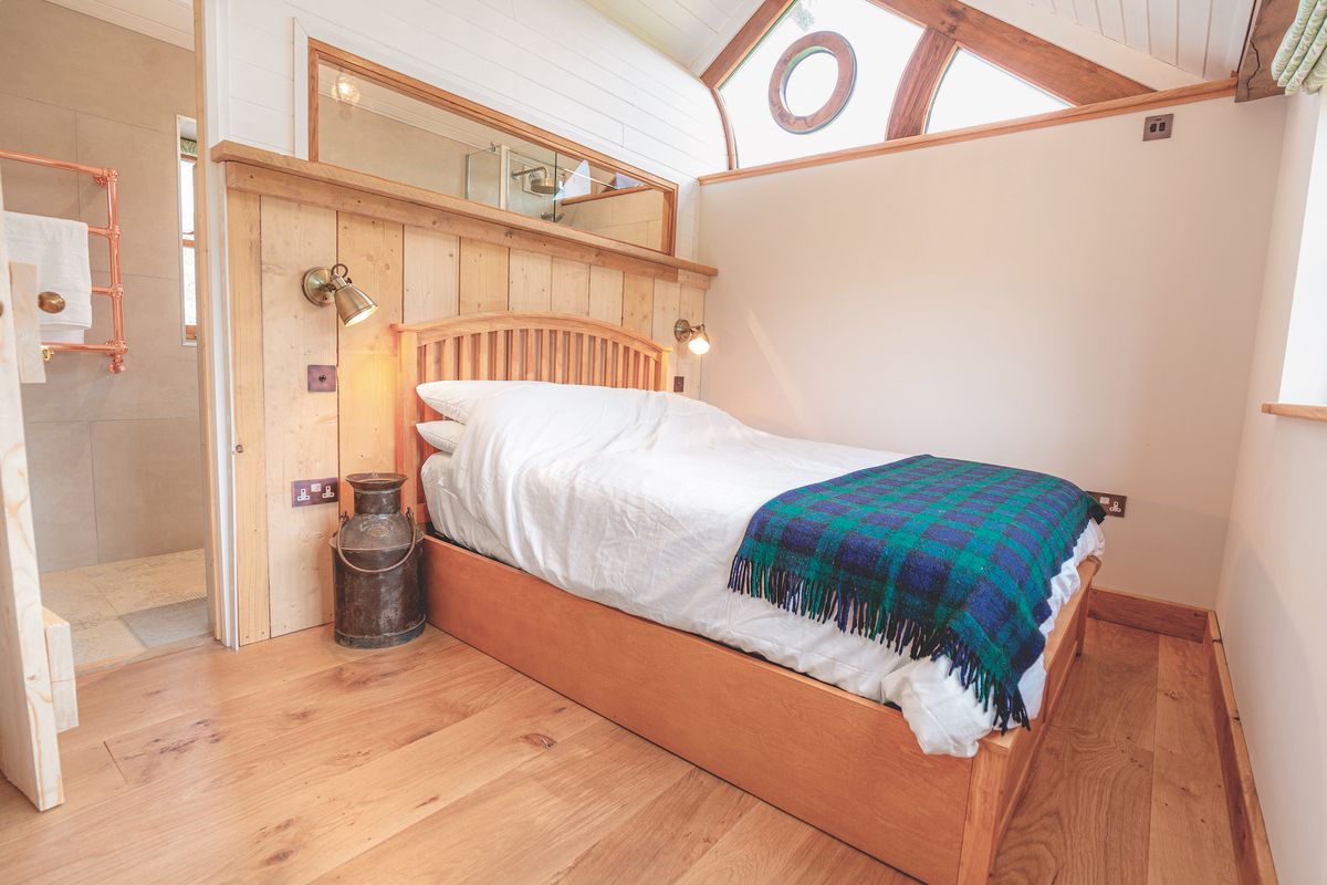 bedroom with vaulted ceiling and triangular window