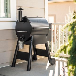Traeger Pro575 smart barbecue on a decked area of a house