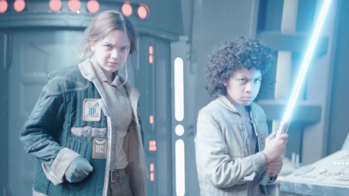 Fern and Wim, who&#039;s holding a blue lightsaber, in Star Wars: Skeleton Crew