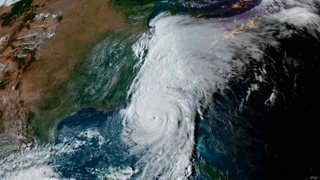 A hurricane is seen in satellite footage of Earth.