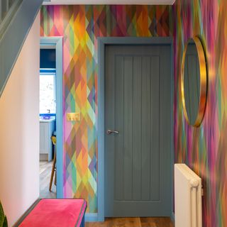 hallway with colourful wallpaper and blue woodwork