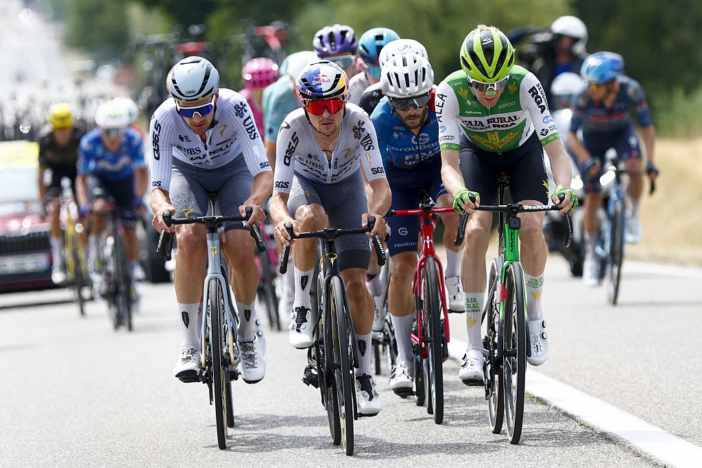Belgian Brent Van Moer (L) of Pinarello-Q36.5 Pro Cycling Team and British Tom Pidcock (C) of Pinarello Q36.5 Pro Cycling Team pictured during stage 15 of the 2026 Tour de France cycling race, a stage of 184km from Champagnole to Plateau de Solaison, on Sunday 19 July 2026. The 113th edition of the Tour de France starts on Saturday 4 July in Barcelona, Spain, and will finish in Paris, France on the 26th of July. BELGA PHOTO POOL LUCA BETTINI (Photo by POOL LUCA BETTINI / BELGA MAG / Belga via AFP)