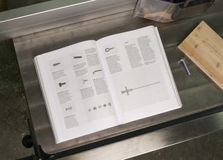 U Joints book open on a metal table in a workshop