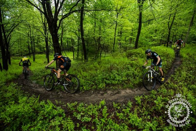 Riders make their way through flowy singletrack between road sections on stage 4.