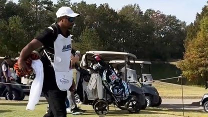 Tiger Woods caddying for his son Charlie
