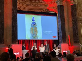 Ina Schieferdecker from Germany collects her overall winner's prize from president of the CEWE Photo Award jury, Yann Arthus-Bertrand, and CEWE chairman Dr Christian Friege