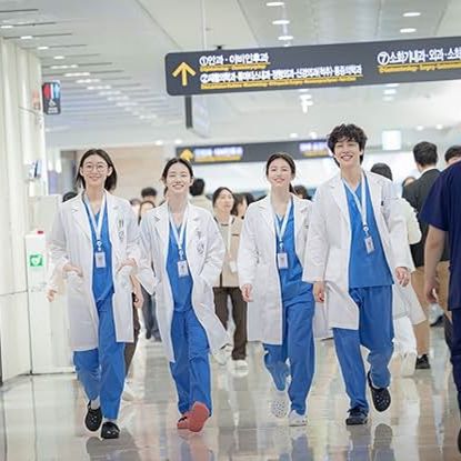 Four doctors walk down a crowded hallway, in 'Resident Playbook.'