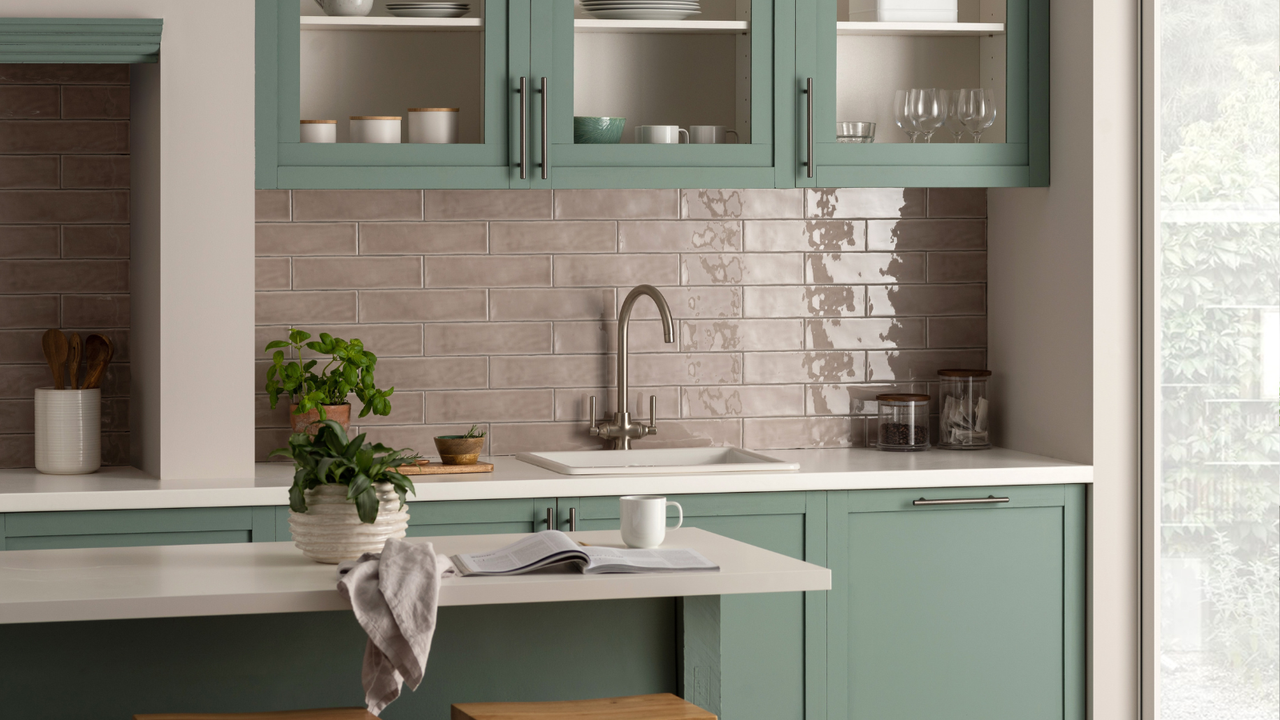 Green kitchen with pink tiles