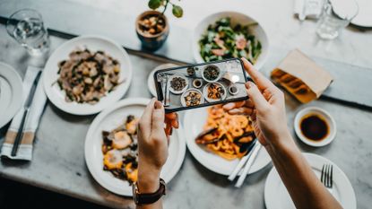 Woman taking a photo of healthy meals