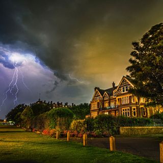 exterior of house with lightning and green lawn