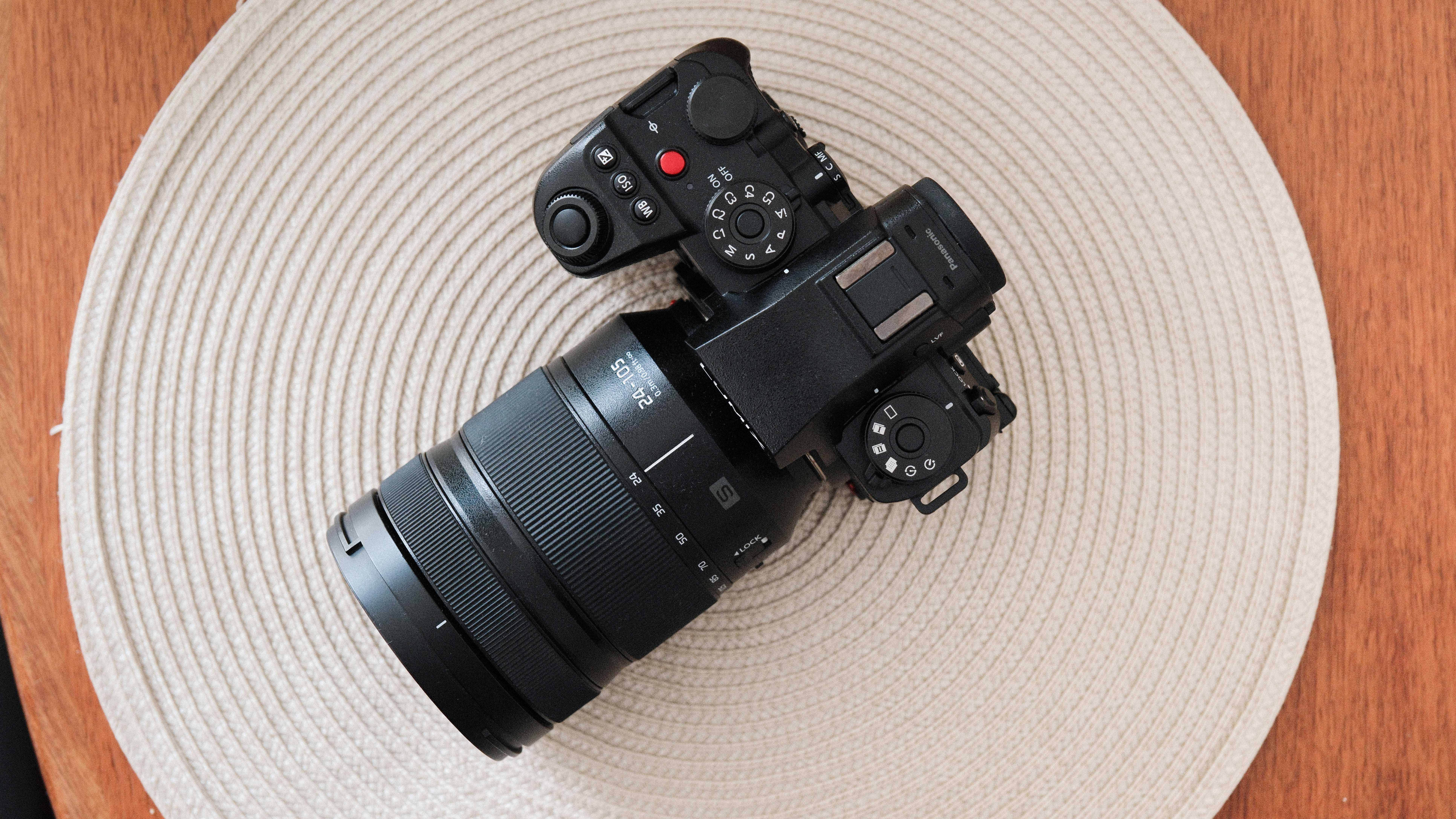 Panasonic Lumix S1 II camera on a beige mat on a wooden table