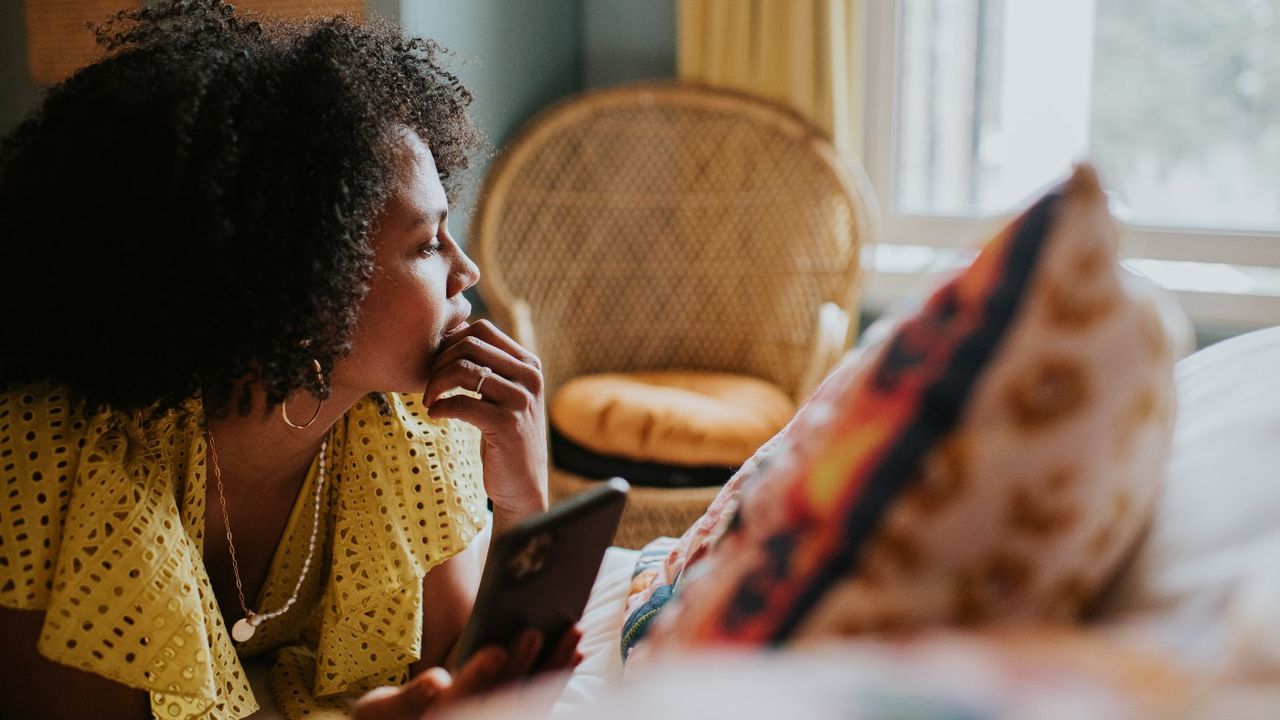 Woman on a sofa looking at her phone