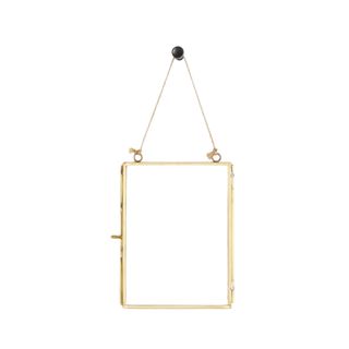 A rectangular gold hanging mirror