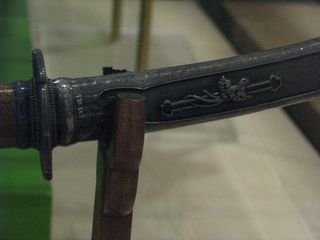 This picture shows the hilt of a tachi (slung sword), dating to 1861, which would have been used by a high-ranking young Samurai.