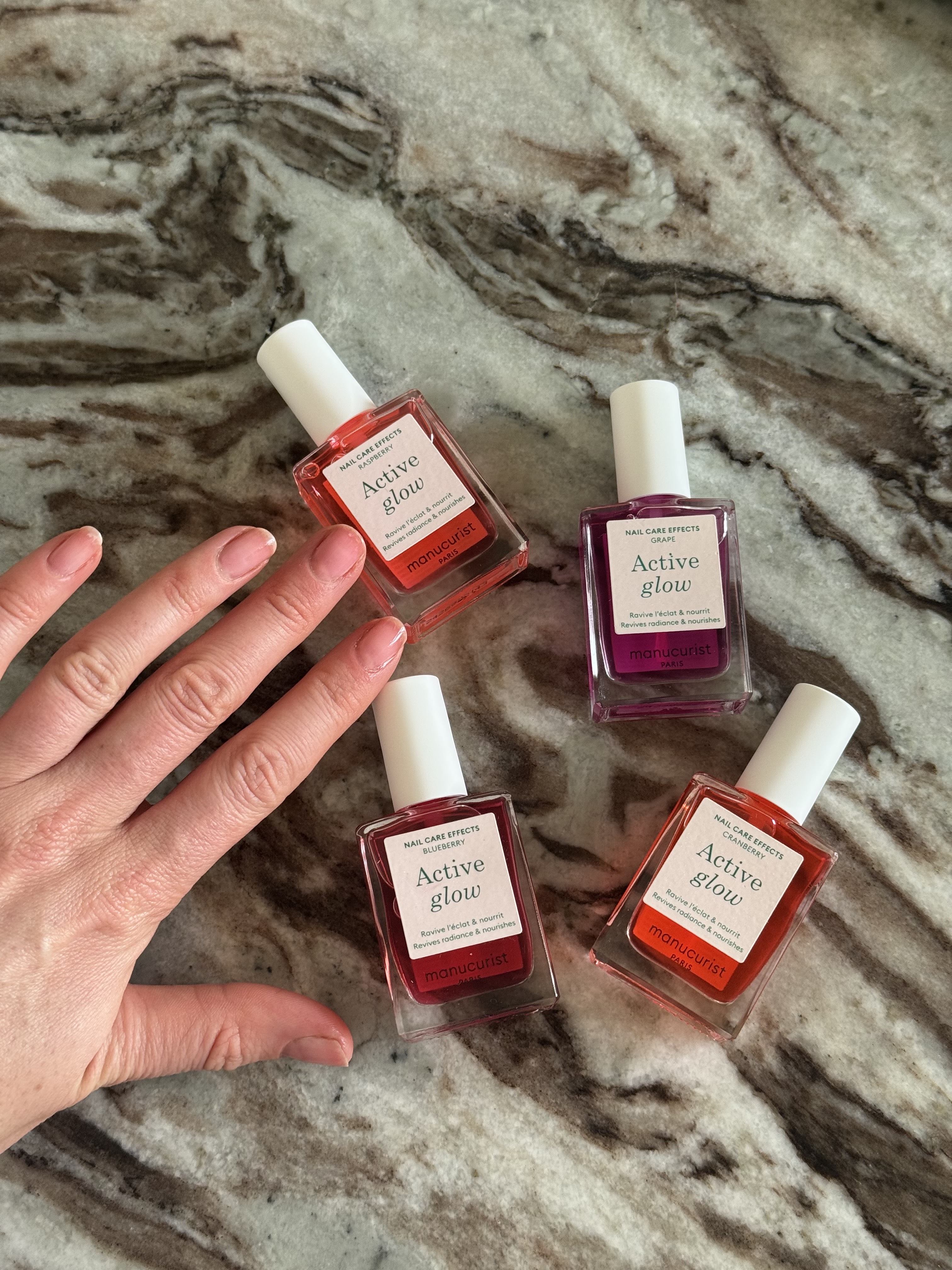 Manucurist Active Glow nail polishes on a marble table