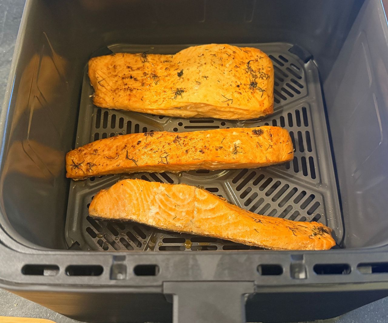 The GreenPan Bistro 360 Air Fryer open showin cooked salmon fillets