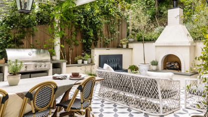 bistro-style outdoor kitchen with tiled floors and an outdoor fireplace