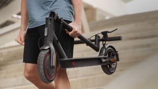 Man ccarrying an Xiaomi Mi Pro 2 down some stairs