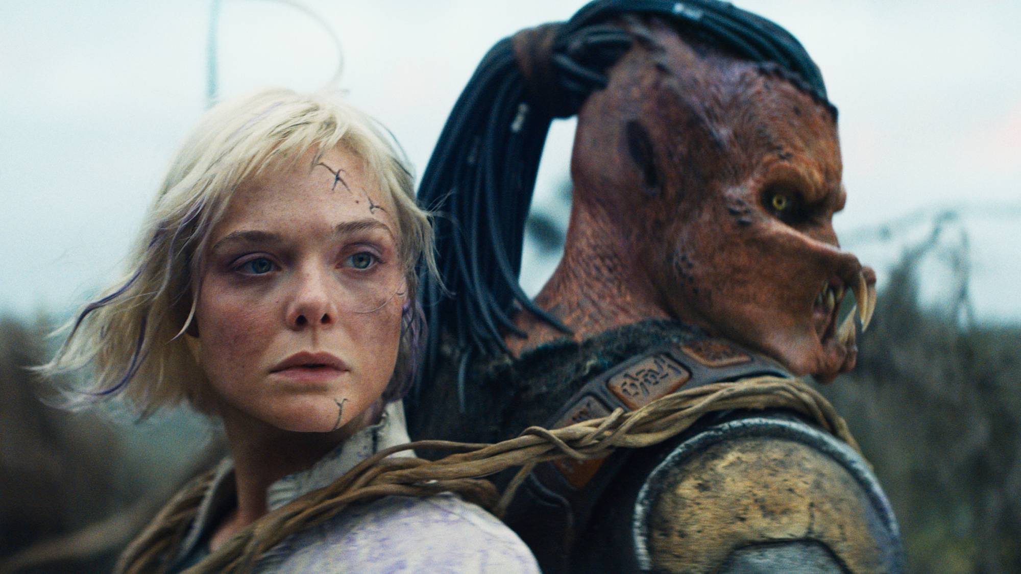 Thia (Elle Fanning) and Dek (Dimitrius Schuster-Koloamatangi) in 20th Century Studios' "Predator: Badlands" 