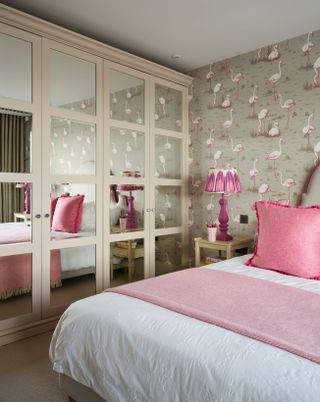 Girls bedroom with pink and grey decor, flamingo wallpaper and built in mirrored wardrobes