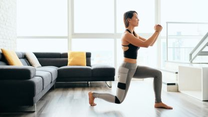 Woman is doing a leg workout in a living room