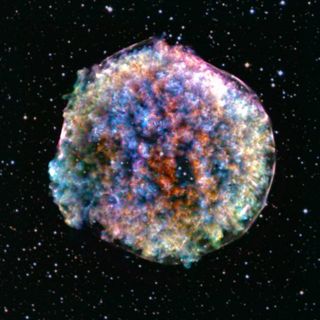 A colorful orb with a blurred appearance on the background of space, which is speckled with stars.