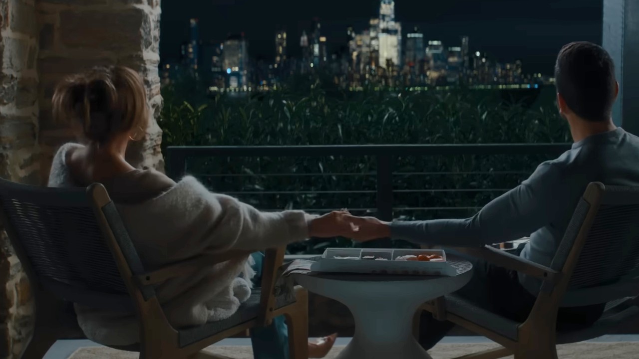 Jennifer Lopez and Brett Goldstein holding hands in Office Romance.