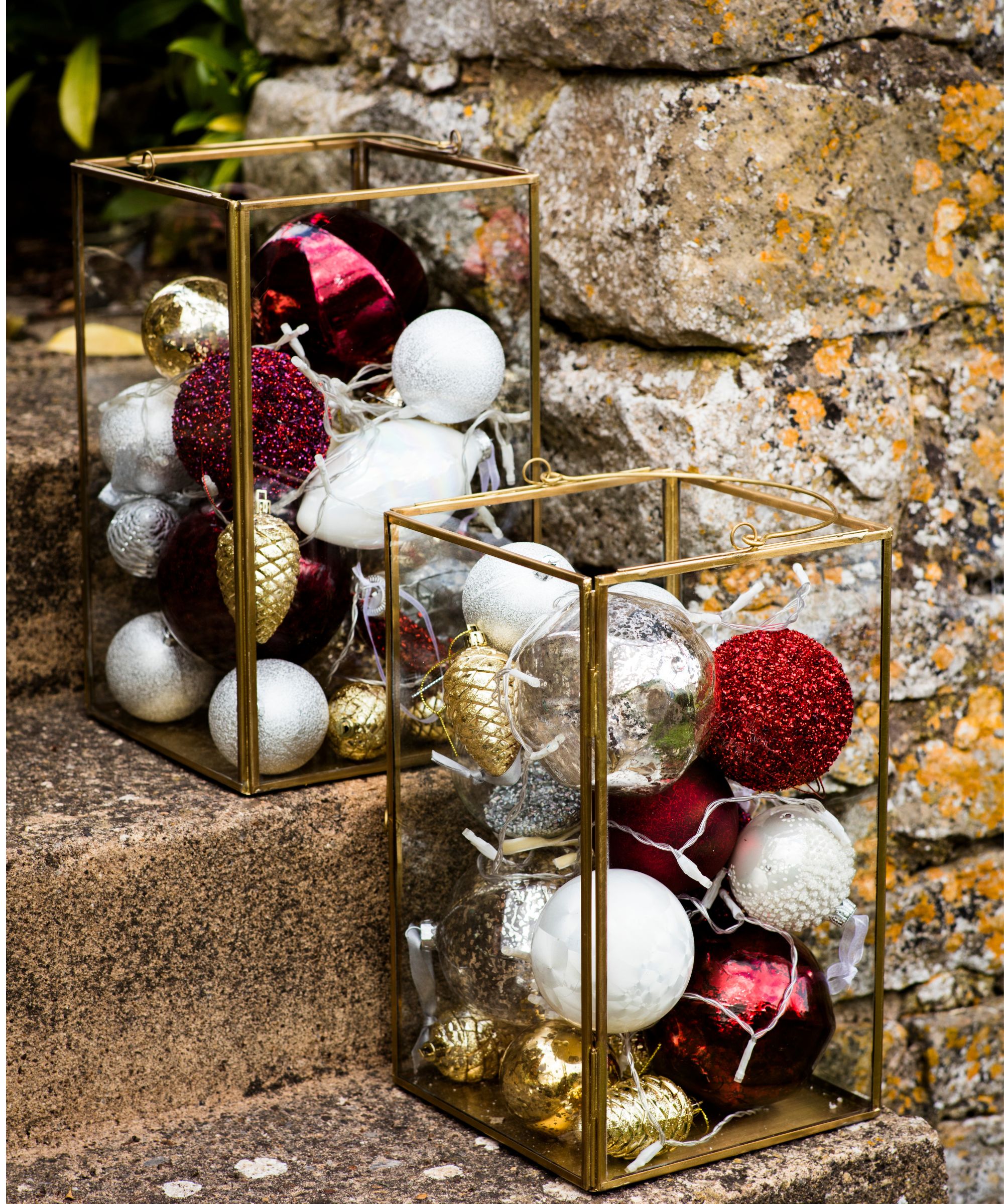 Gold-rimmed glass vases filled with white, red and gold ornaments