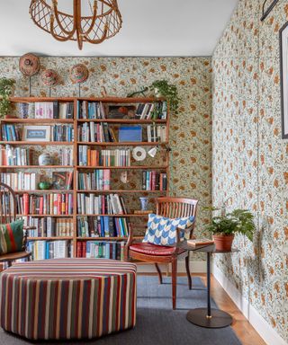 Large bookshelf, patterned wallpaper, wooden furniture