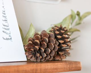 Pine cones used to decorate a Christmas mantel