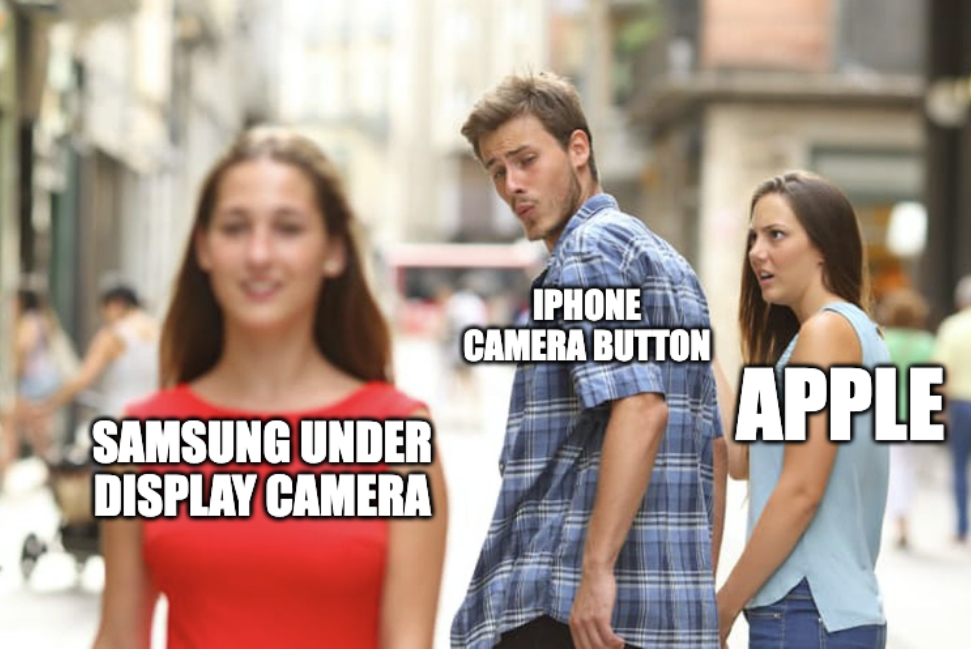 Distracted Boyfriend meme, depicting the girlfriend (Apple) looking at her boyfriend (iPhone Camera Button) being distracted by another woman (Samsung Under Display Camera)