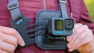 A man clipping in the buckle on the front of the GoPro Chesty V2 harness