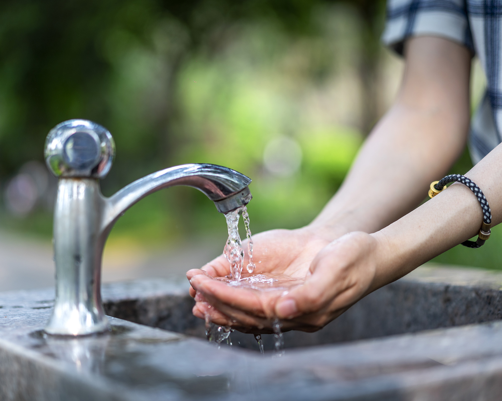 Gardener washes hands in outside basin