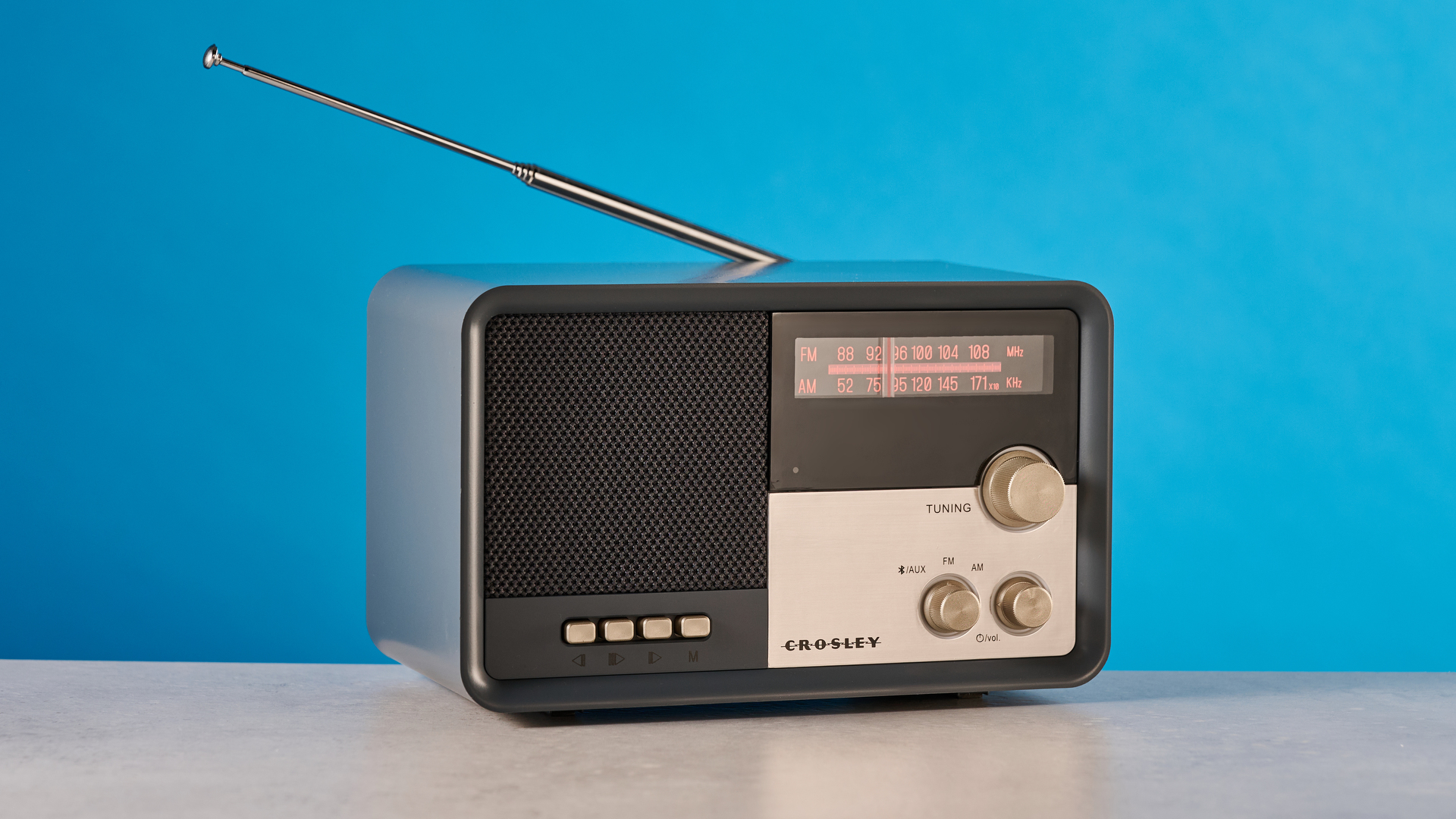 Crosley Tribute Radio in gray color photographed on a blue background