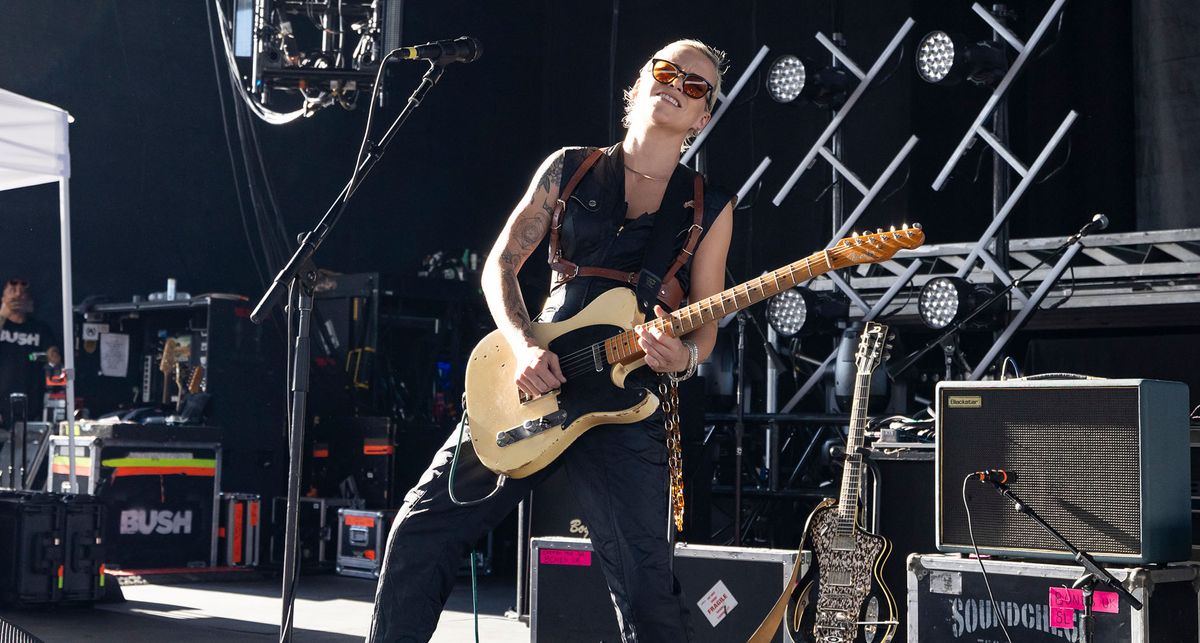 Carmen Vandenberg wears shades and plays a blazing solo on her Butterscotch Blonde Fender Telecaster in the summer sun at a festival appearance. 